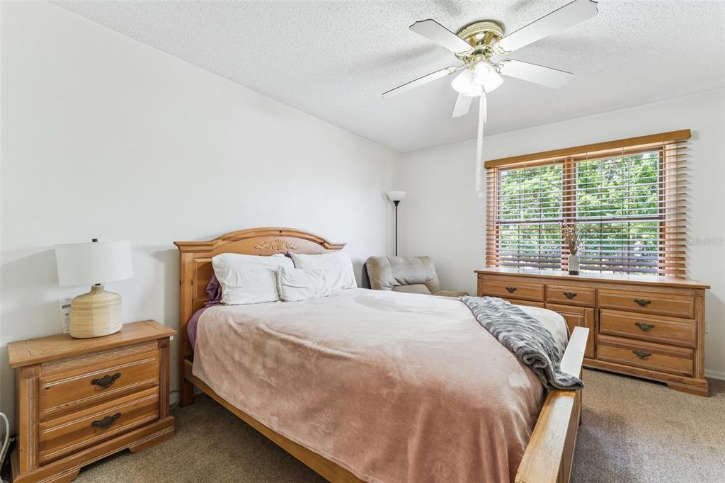 1017 Monroe Avenue St. Cloud, FL 34769 - Photo 20 of 53 a bedroom with a bed and a chandelier
