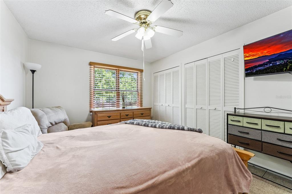 1017 Monroe Avenue St. Cloud, FL 34769 - Photo 21 of 53 a bedroom with a bed and a chandelier