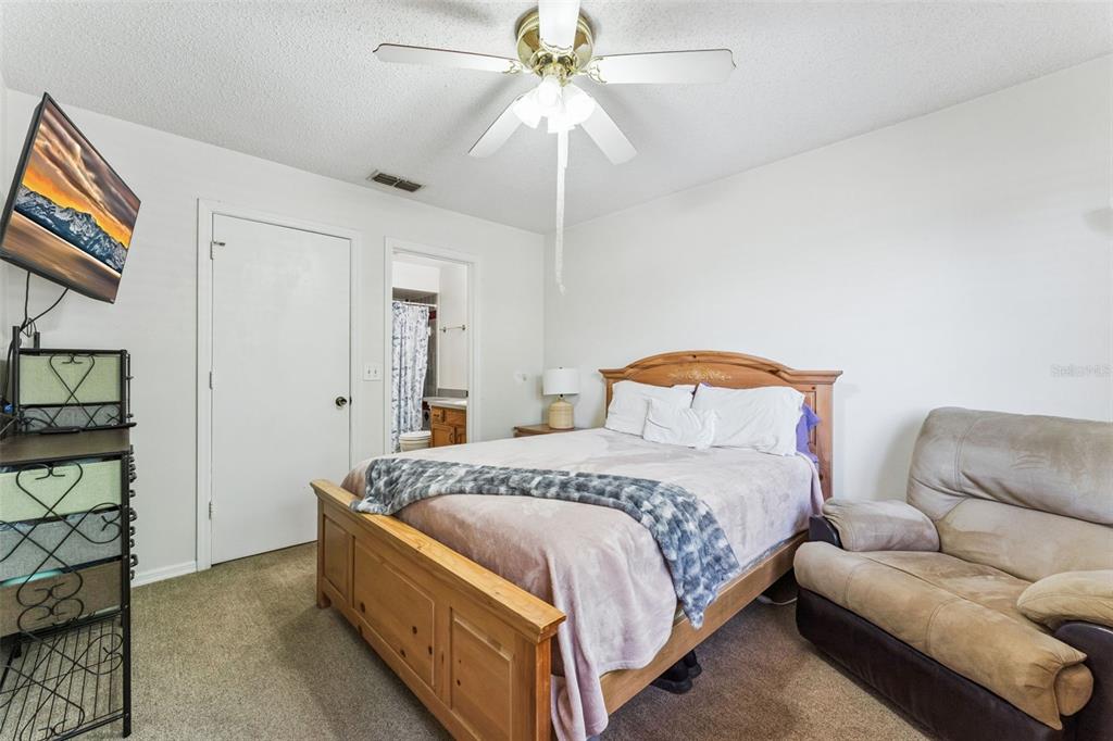 1017 Monroe Avenue St. Cloud, FL 34769 - Photo 22 of 53 a bedroom with bed and a chandelier