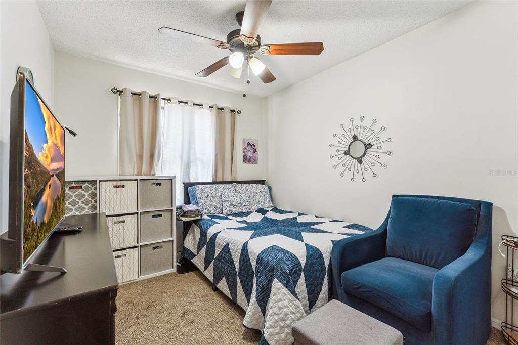 1017 Monroe Avenue St. Cloud, FL 34769 - Photo 24 of 53 a bedroom with a bed couch and a window