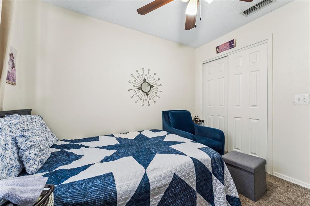 1017 Monroe Avenue St. Cloud, FL 34769 - Photo 25 of 53 a bedroom with a bed and a chandelier