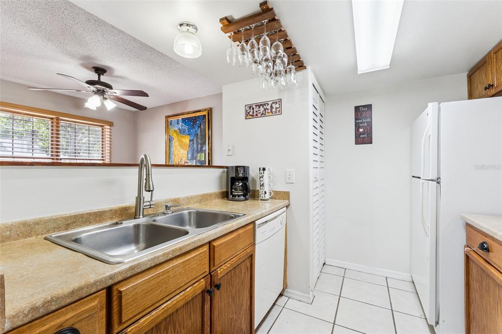 1017 Monroe Avenue St. Cloud, FL 34769 - Photo 7 of 53 a kitchen with a sink and a refrigerator