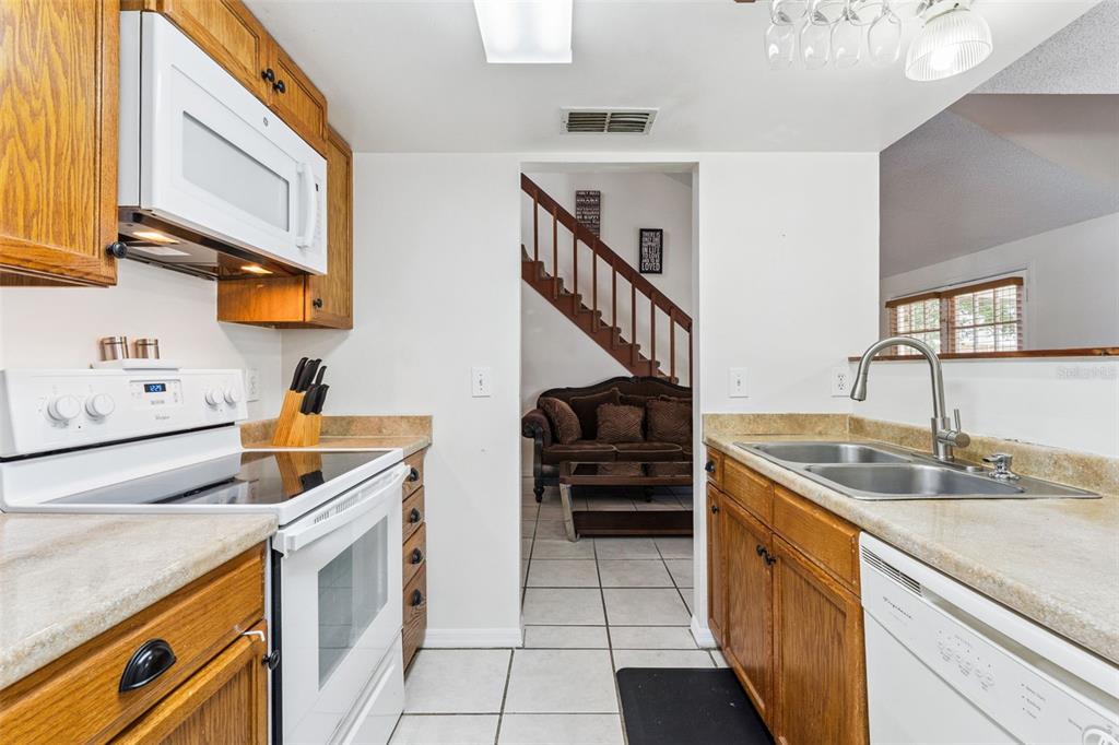 1017 Monroe Avenue St. Cloud, FL 34769 - Photo 10 of 53 a kitchen with stainless steel appliances granite countertop a sink and cabinets