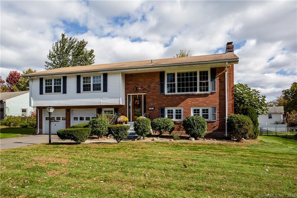 155 Ridge Crest Circle Wethersfield, CT 06109 - Photo 1 of 1 a front view of a house with garden
