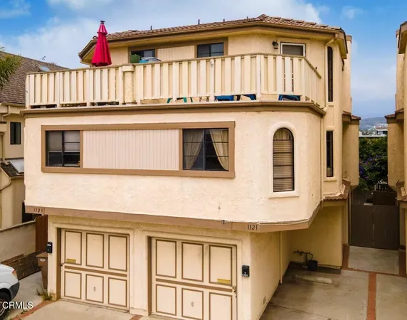 a view of a house with wooden fence