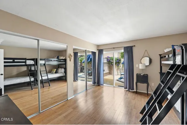a view of a livingroom with furniture wooden floor and windows