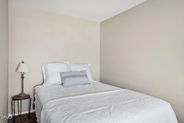 a bedroom with a bed and a night stand