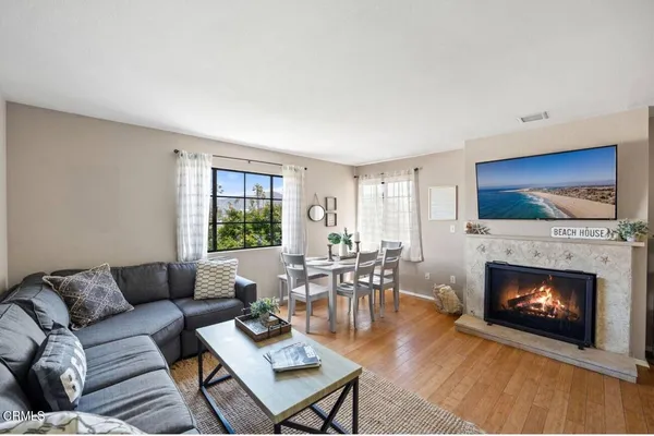 a living room with furniture a flat screen tv and a fireplace