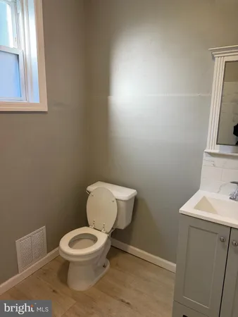 a white toilet sitting next to a bathroom sink