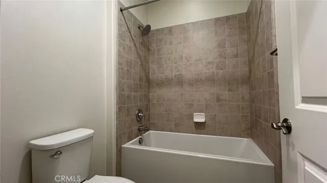 a white bath tub sitting next to a toilet