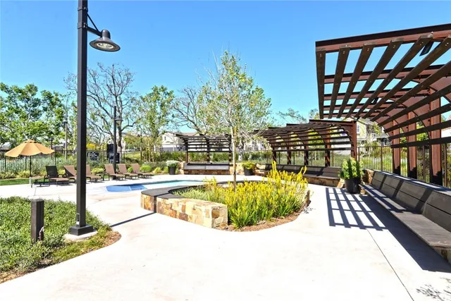 a view of a swimming pool with a patio and a yard
