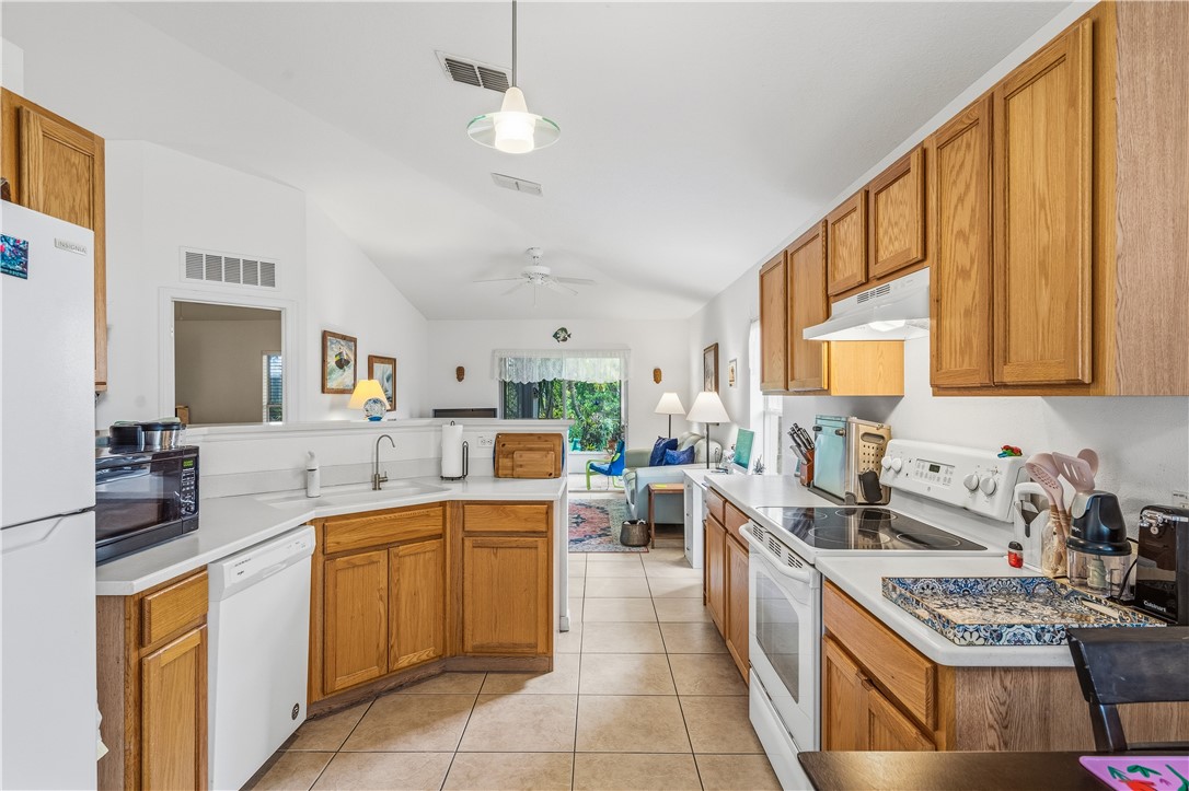 131 Bellamy Trail Sebastian, FL 32958 - Photo 13 of 32 a kitchen with a sink stove and cabinets