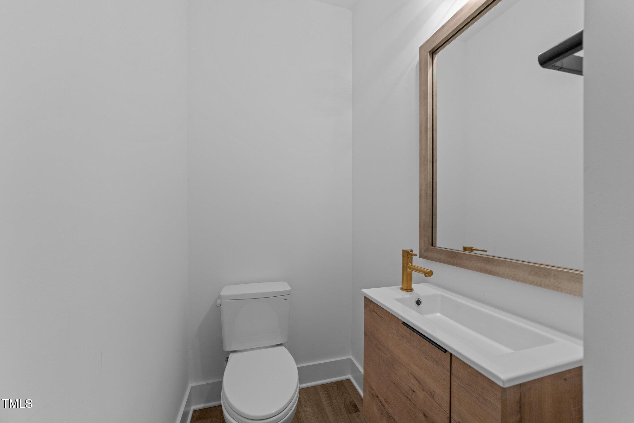 710 West North Street, Unit 102 Raleigh, NC 27603 - Photo 21 of 37 a white toilet sitting next to a bathroom sink