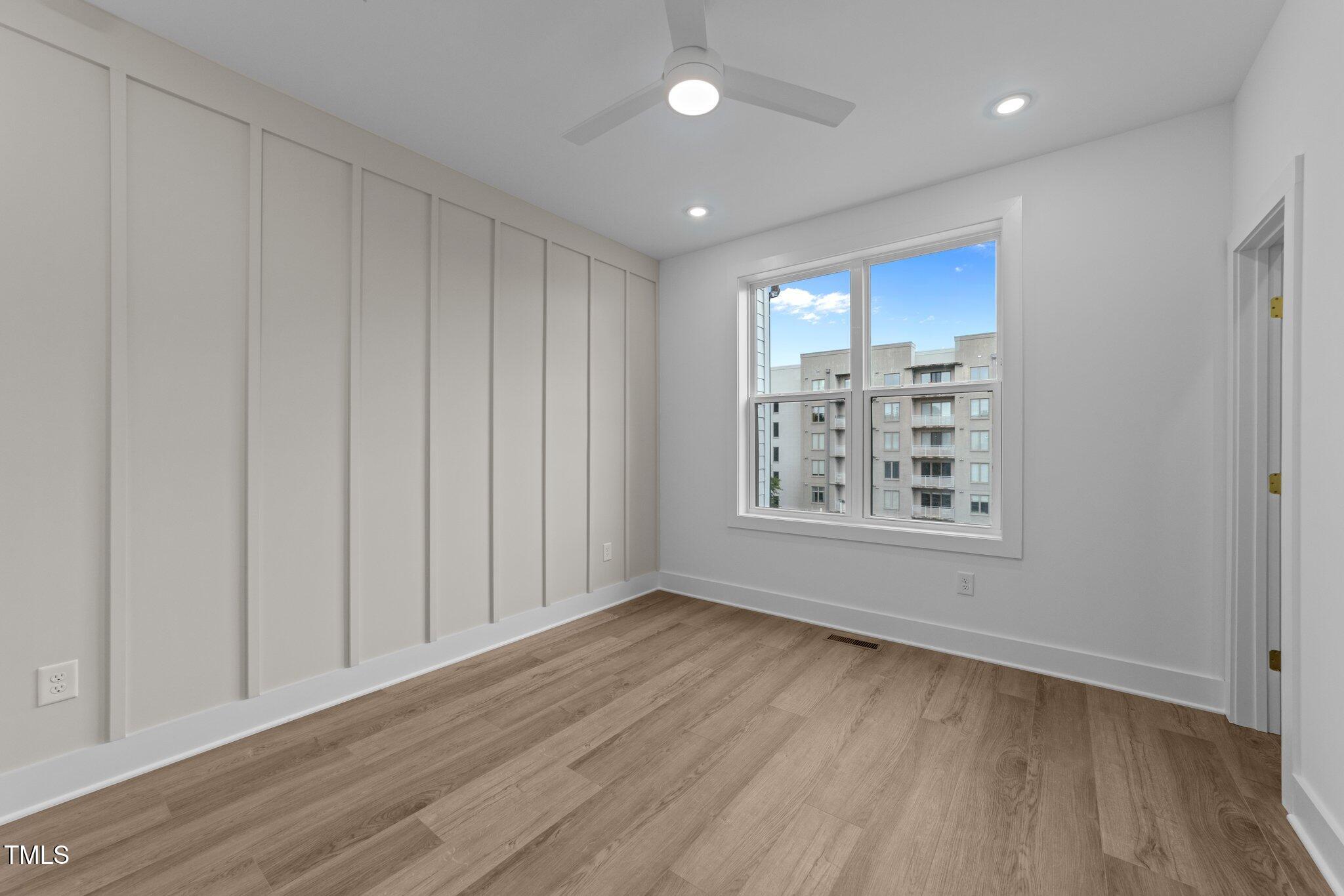 710 West North Street, Unit 102 Raleigh, NC 27603 - Photo 22 of 37 wooden floor in an empty room with a window