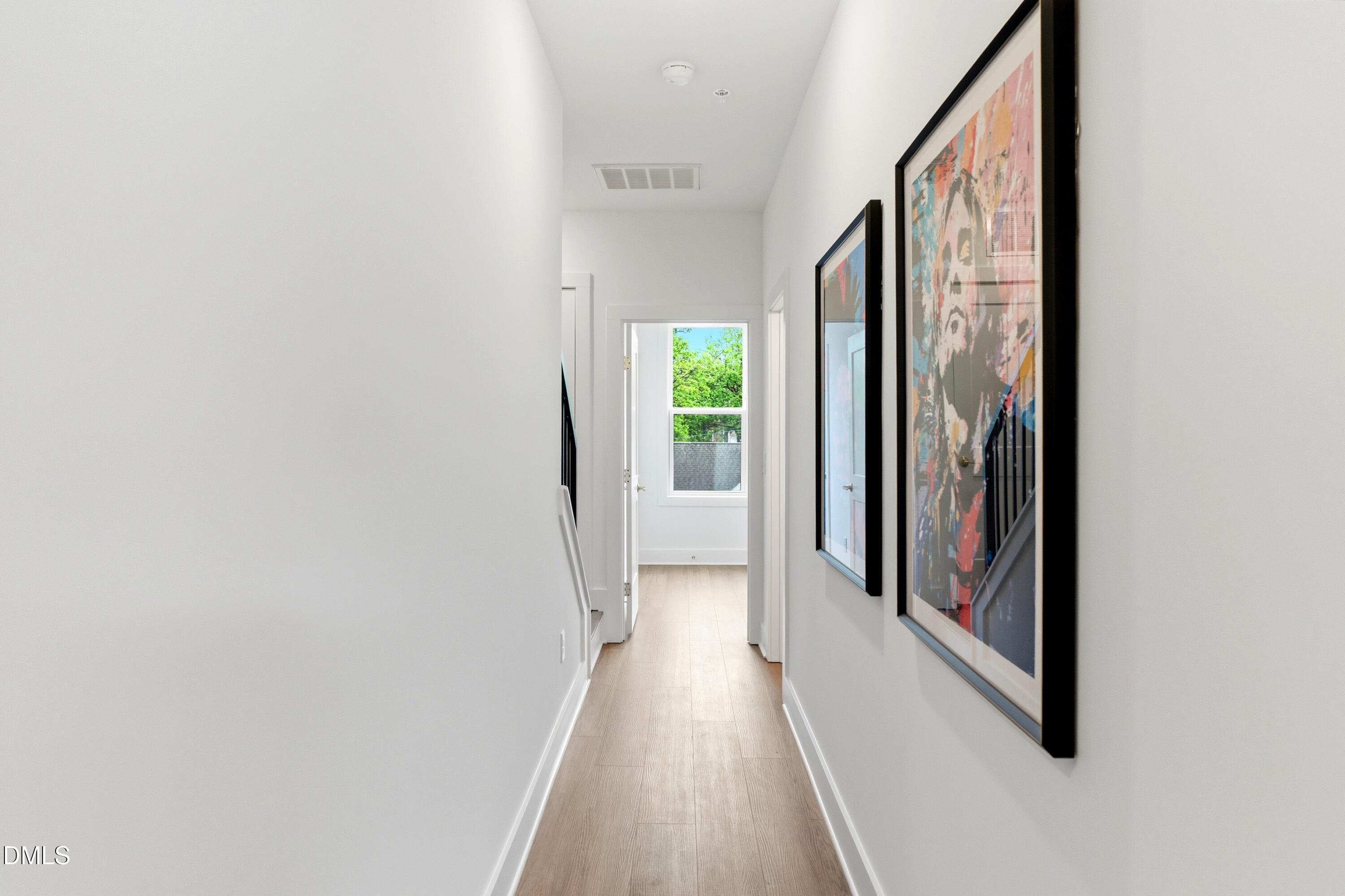 710 West North Street, Unit 102 Raleigh, NC 27603 - Photo 24 of 44 a view of a hallway with wooden floor and staircase