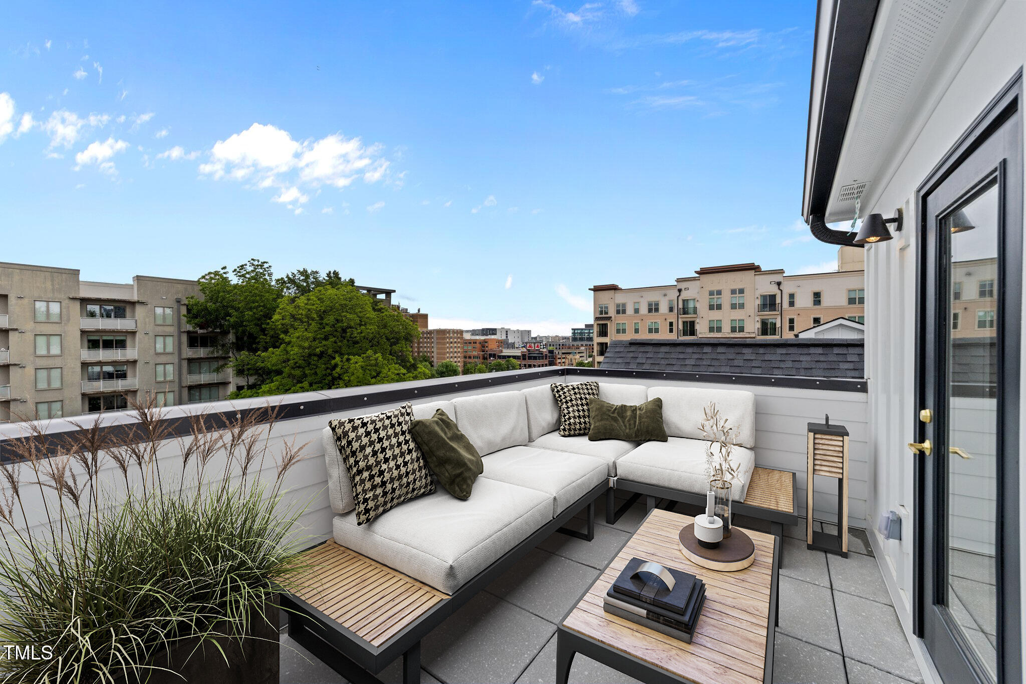 710 West North Street, Unit 102 Raleigh, NC 27603 - Photo 33 of 37 a balcony with outdoor seating and city view