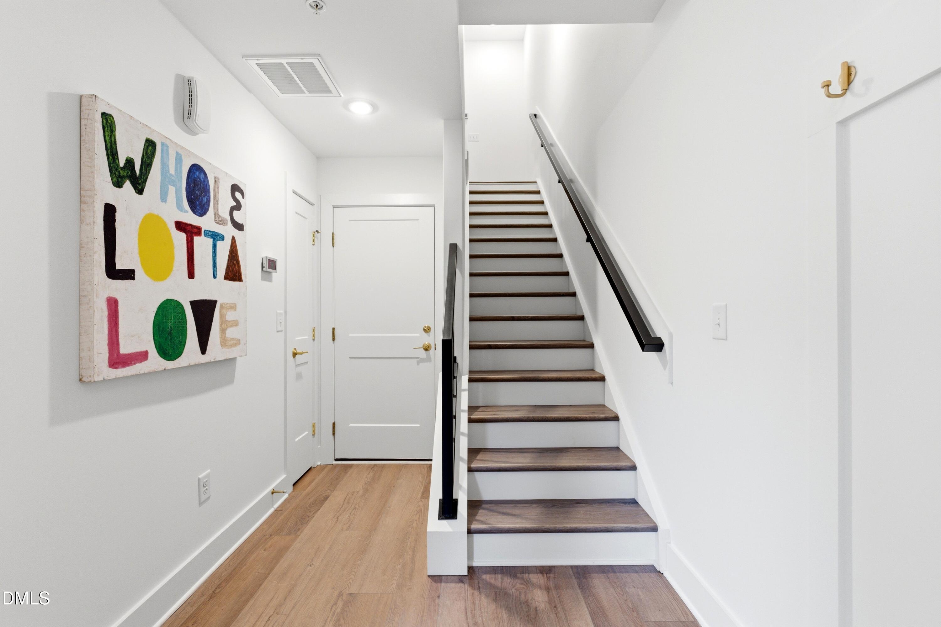 710 West North Street, Unit 102 Raleigh, NC 27603 - Photo 5 of 44 a view of entryway with stairs and wooden floor