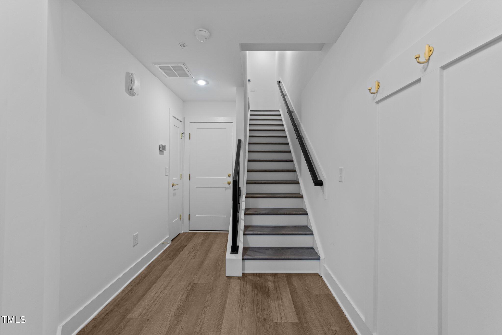 710 West North Street, Unit 102 Raleigh, NC 27603 - Photo 7 of 37 a view of a hallway with wooden floor and entryway