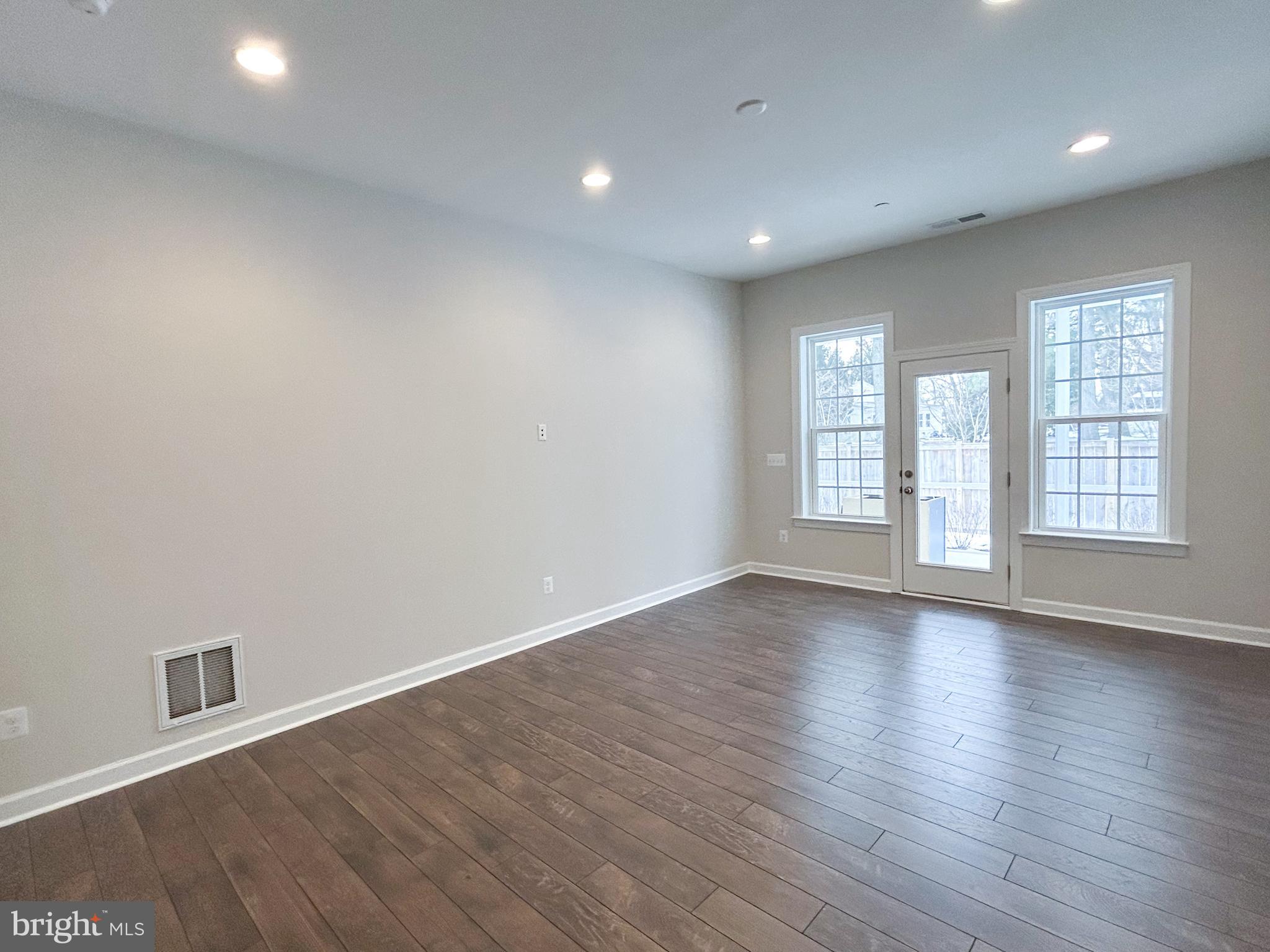 1003 Champlain Court Trappe, MD 21673 - Photo 15 of 55 an empty room with wooden floor and windows