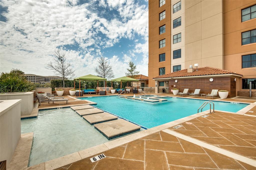 330 Las Colinas Boulevard East, Unit 924 Irving, TX 75039 - Photo 13 of 20 a view of a swimming pool with lawn chairs and a yard
