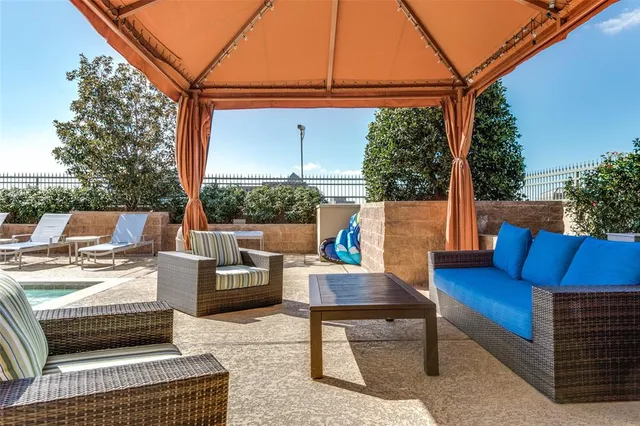 a view of a patio with couches chairs and a fire pit