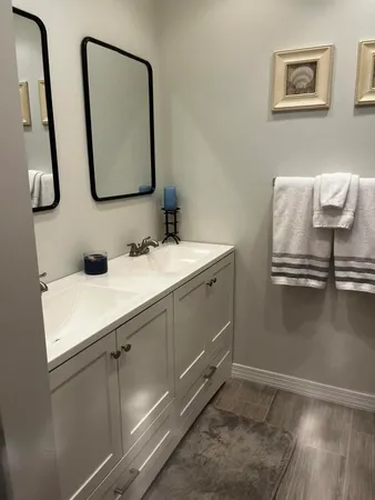 a bathroom with a double vanity sink and mirror