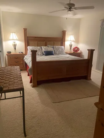 a bedroom with furniture and a lamp