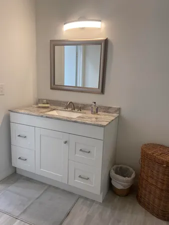 a bathroom with a toilet sink and mirror