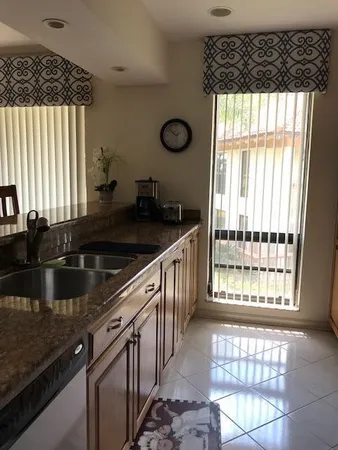 a kitchen with granite countertop a sink and a window