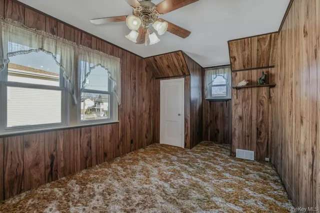 a view of a hallway with entryway and stairs