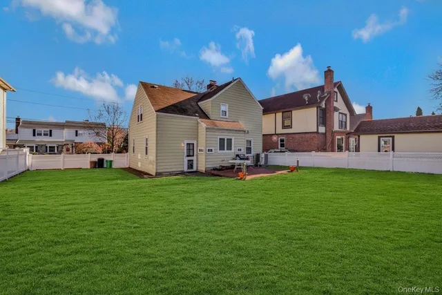 a view of a house with a yard and sitting area