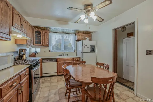 a dining table with chairs and kitchen view
