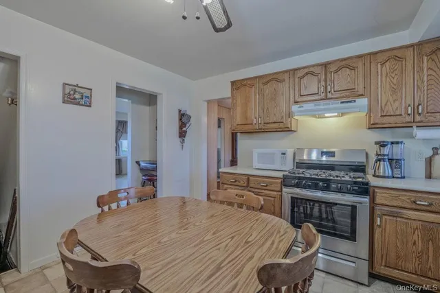 a kitchen with stainless steel appliances granite countertop a stove a sink dishwasher and cabinets with wooden floor
