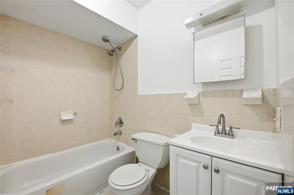 44 1/2 3rd Street, Unit 2 Newark, NJ 07107 - Photo 12 of 15 a bathroom with a sink a toilet and bathtub