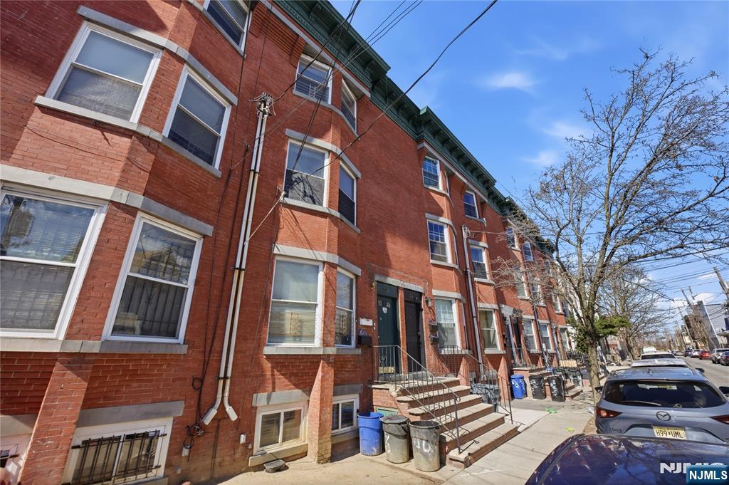 44 1/2 3rd Street, Unit 2 Newark, NJ 07107 - Photo 2 of 15 a front view of a building with a yard
