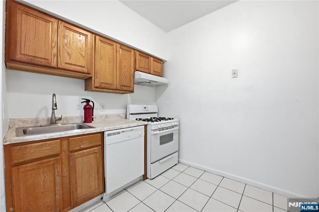 44 1/2 3rd Street, Unit 2 Newark, NJ 07107 - Photo 5 of 15 a kitchen with a sink cabinets and appliances