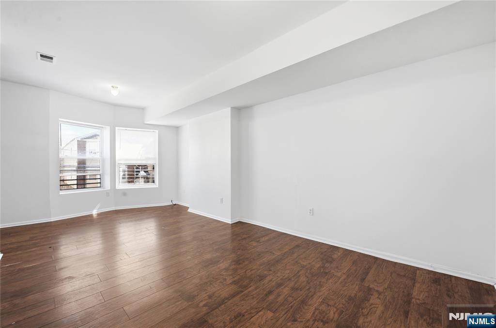 44 1/2 3rd Street, Unit 2 Newark, NJ 07107 - Photo 6 of 15 a view of an empty room with wooden floor and a window