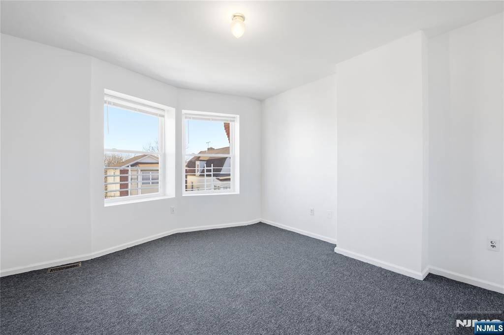 44 1/2 3rd Street, Unit 2 Newark, NJ 07107 - Photo 7 of 15 an empty room with windows