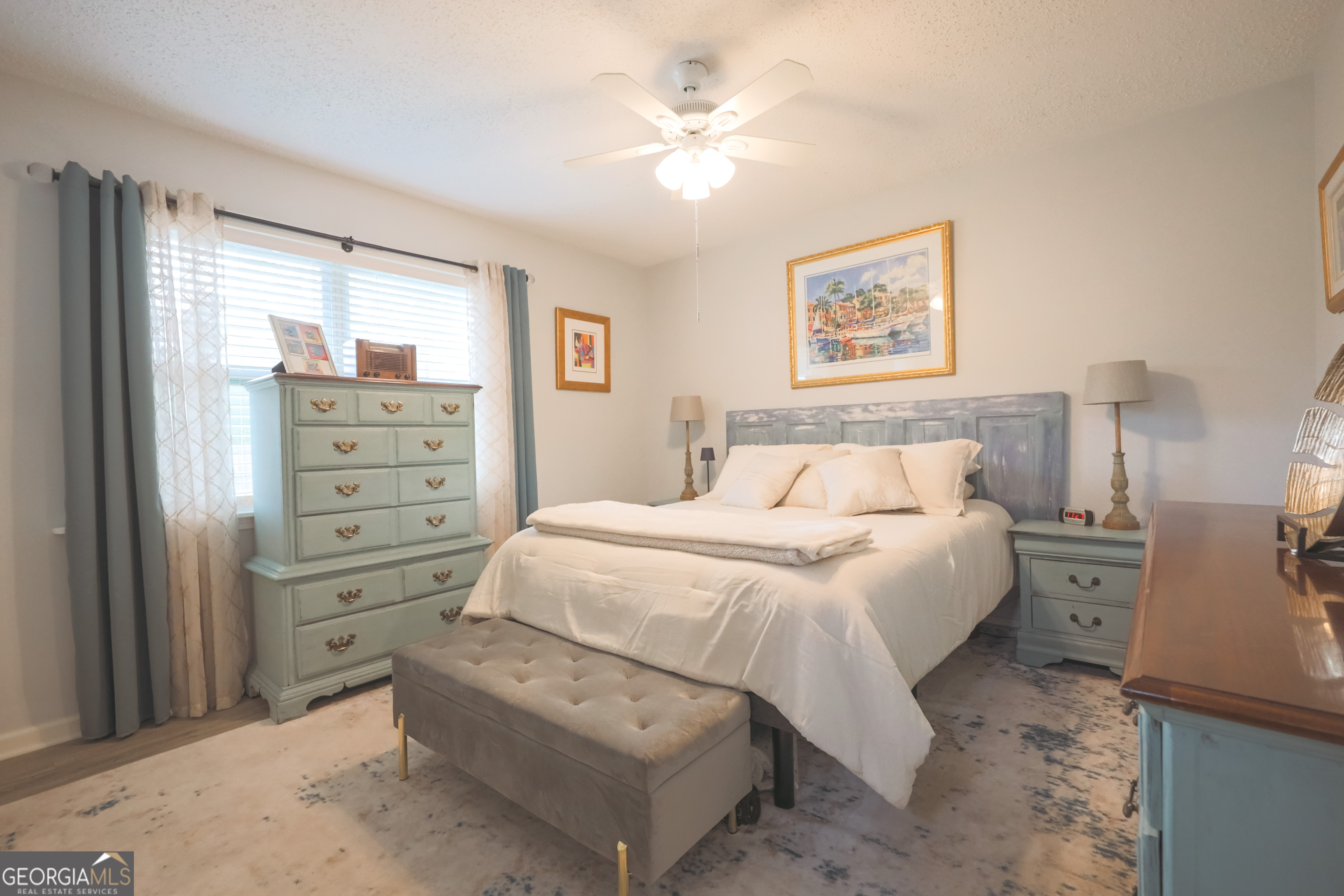 106 Beaver Drive Blackshear, GA 31516 - Photo 19 of 20 a bedroom with a bed and a chandelier