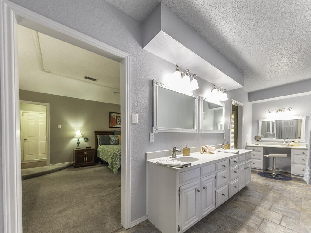 3620 93rd Street Lubbock, TX 79423 - Photo 17 of 33 a bathroom with a sink double vanity and a mirror