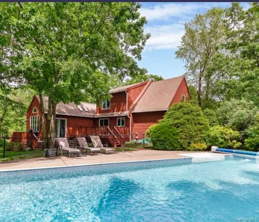 a view of a patio with table and chairs under an umbrella