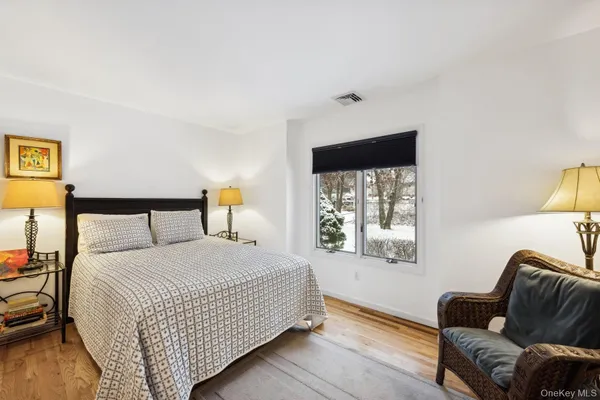 a bedroom with a bed couch and window