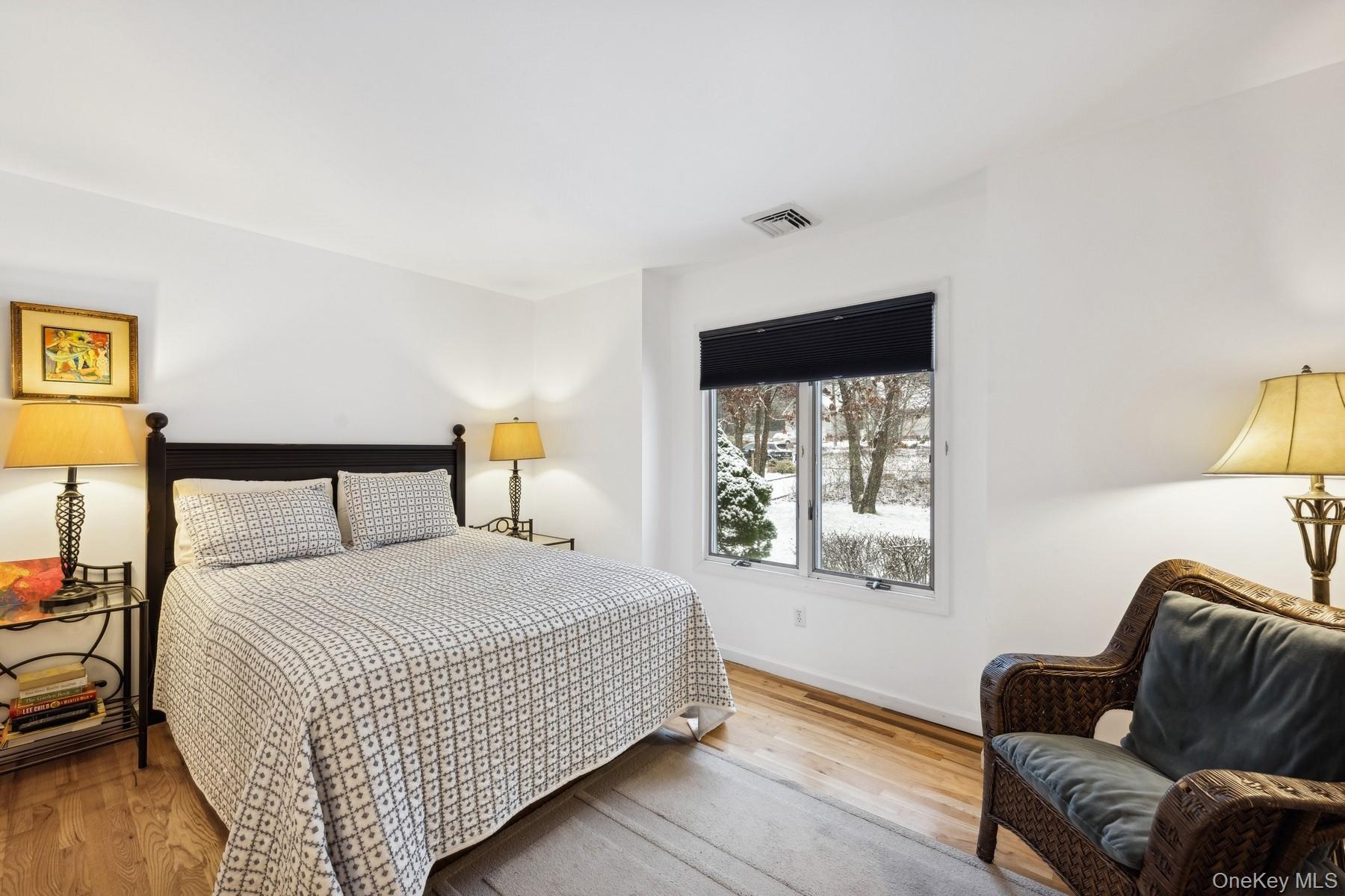 12 Hildreth Road Hampton Bays, NY 11946 - Photo 11 of 21 a bedroom with a bed couch and window