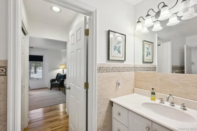 a en suite bathroom with a sink double vanity granite and a shower