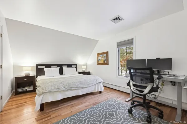 a bedroom with a bed a desk and chair