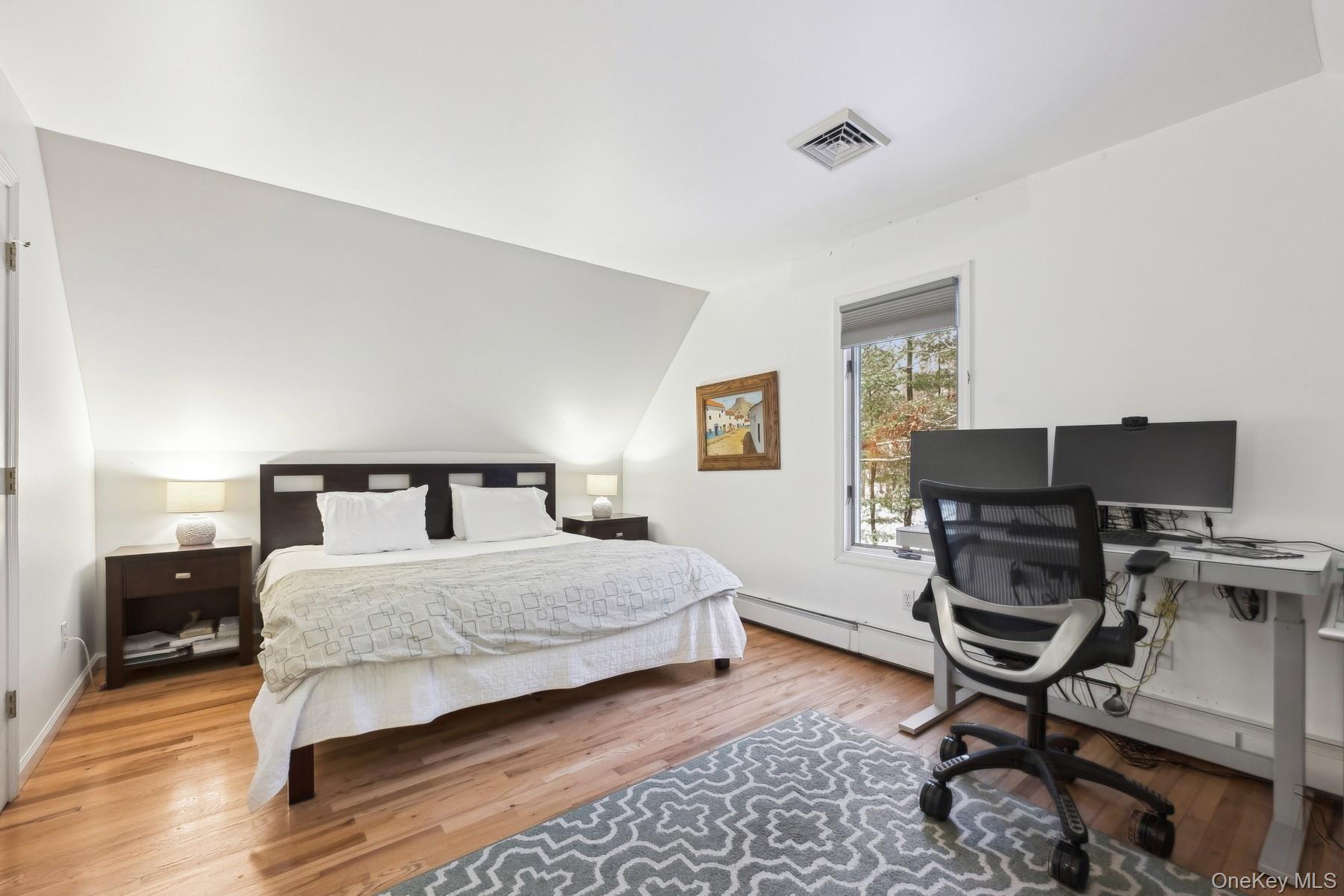 12 Hildreth Road Hampton Bays, NY 11946 - Photo 15 of 21 a bedroom with a bed a desk and chair
