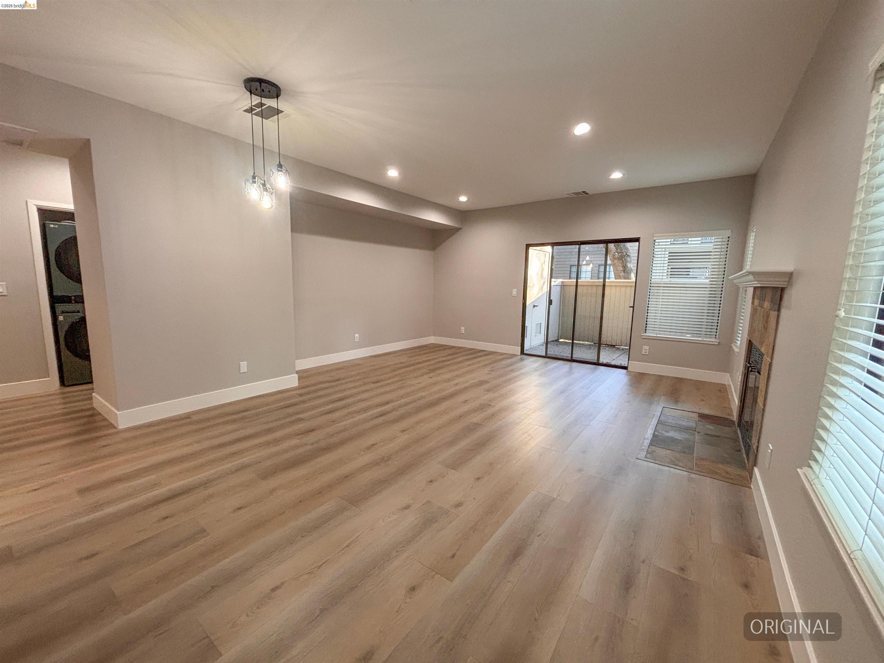 450 Pine Ridge Drive San Ramon, CA 94582 - Photo 5 of 18 an empty room with wooden floor and windows