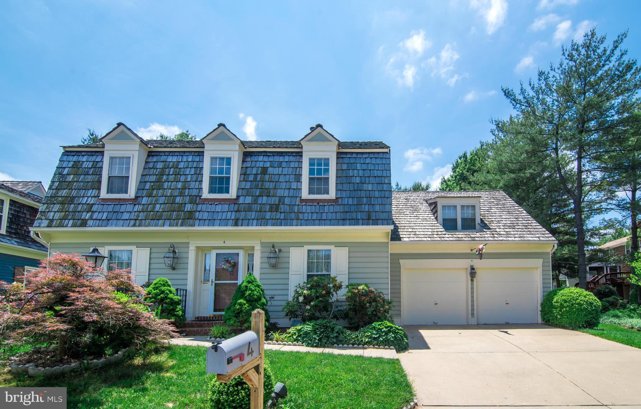 4 Midsummer Court Gaithersburg, MD 20878 - Photo 1 of 24 a front view of a house with yard and green space