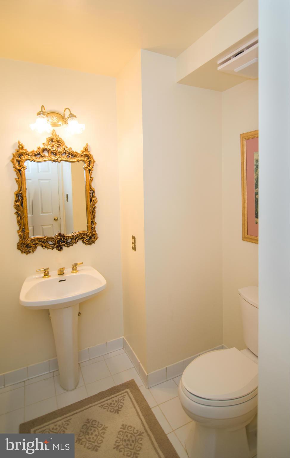 4 Midsummer Court Gaithersburg, MD 20878 - Photo 11 of 24 a bathroom with a sink a toilet and mirror