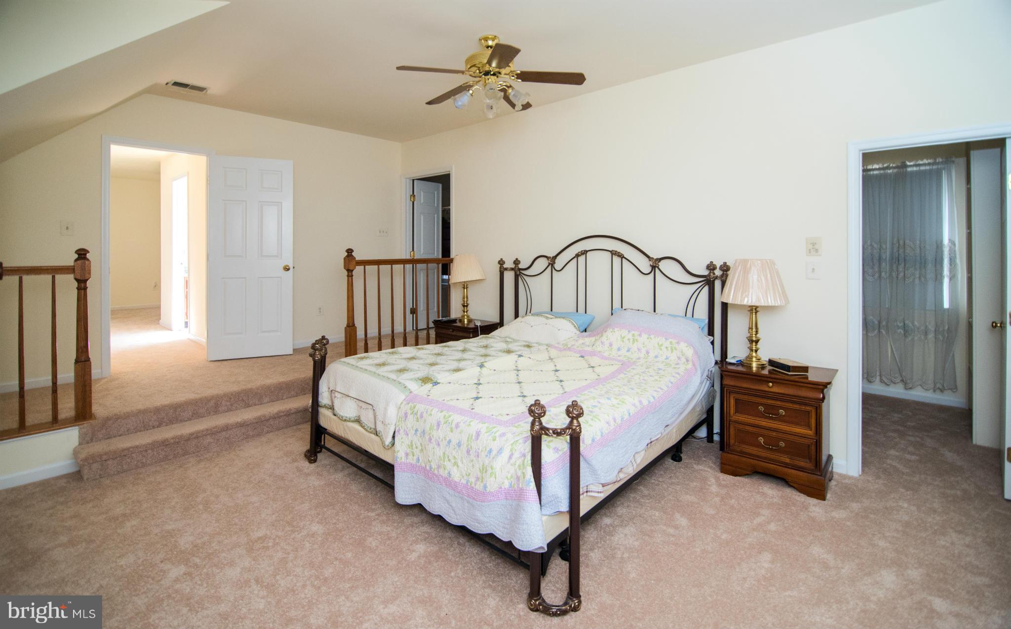 4 Midsummer Court Gaithersburg, MD 20878 - Photo 12 of 24 a bedroom with a bed and a chandelier